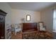 Bedroom featuring a rocking chair, wicker chair, dresser with mirror, and neutral paint at 11624 Buttonwood Dr, Carmel, IN 46033