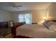 Spacious bedroom with hardwood floors, ceiling fan, and a large bed with pillows at 11624 Buttonwood Dr, Carmel, IN 46033