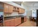 Open kitchen featuring wood cabinets, granite countertops, and a view to the dining area at 11624 Buttonwood Dr, Carmel, IN 46033
