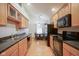 Bright kitchen featuring wood cabinets, black appliances, stone counters and a breakfast nook with views at 11624 Buttonwood Dr, Carmel, IN 46033