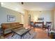 Bright living room with vaulted ceilings, neutral paint, wood floors, and cozy furnishings at 11624 Buttonwood Dr, Carmel, IN 46033
