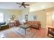 Comfortable living room with natural light, warm paint, wood floors, and comfortable seating at 11624 Buttonwood Dr, Carmel, IN 46033