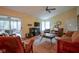 Spacious living room with fireplace, wood floors, and access to the sunroom at 11624 Buttonwood Dr, Carmel, IN 46033