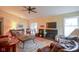 Open-concept living room featuring a fireplace, wood floors, and a sliding door to the outside at 11624 Buttonwood Dr, Carmel, IN 46033