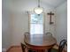 Breakfast nook with wood floors, cross decoration, and window with sheer white curtains at 11624 Buttonwood Dr, Carmel, IN 46033