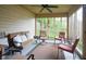 Screened porch with comfortable seating, fan, area rug and view of the backyard at 11624 Buttonwood Dr, Carmel, IN 46033