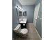 Bathroom with tile floor, toilet, and vanity with framed mirror and updated fixtures at 1206 Brownswood Dr, Brownsburg, IN 46112