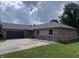 Charming single-story brick home featuring an attached garage and well-maintained lawn at 1206 Brownswood Dr, Brownsburg, IN 46112