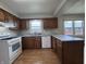 Updated kitchen features wood cabinetry, modern counters, and stainless steel appliances at 1206 Brownswood Dr, Brownsburg, IN 46112