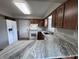 Bright kitchen showcasing updated counters, modern appliances and wooden cabinets at 1206 Brownswood Dr, Brownsburg, IN 46112