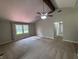 Spacious living room with vaulted ceiling, ceiling fan, large window, and neutral carpet at 1206 Brownswood Dr, Brownsburg, IN 46112