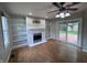 Inviting living room with hardwood floors, fireplace, built-in shelving and sliding glass door to backyard at 1206 Brownswood Dr, Brownsburg, IN 46112