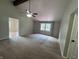 Open-concept living room featuring vaulted ceilings, carpet, and a window to the backyard at 1206 Brownswood Dr, Brownsburg, IN 46112