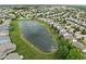 Aerial view of a residential neighborhood featuring a scenic pond with a fountain at 13019 Pinner Ave, Fishers, IN 46037
