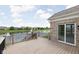 Back deck with black metal railing, a slider to the interior, overlooking large community pond at 13019 Pinner Ave, Fishers, IN 46037