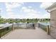 Back deck overlooking community pond with water fountain and neighborhood houses at 13019 Pinner Ave, Fishers, IN 46037