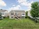 A well-maintained backyard featuring a brick home, a wooden deck with stairs, and a lush green lawn at 13019 Pinner Ave, Fishers, IN 46037