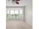Bedroom featuring large bay windows overlooking the lake and neutral carpeting at 13019 Pinner Ave, Fishers, IN 46037