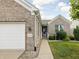 Close-up of front exterior featuring brick facade, address, and white trim at 13019 Pinner Ave, Fishers, IN 46037