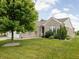 Charming brick home with lush green lawn, mature tree, and white trim at 13019 Pinner Ave, Fishers, IN 46037