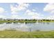 Full view of the community pond and fountain surrounded by well-maintained lawns and neighboring houses at 13019 Pinner Ave, Fishers, IN 46037