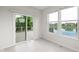 Bright sunroom with sliding glass doors to the deck and windows overlooking the water at 13019 Pinner Ave, Fishers, IN 46037