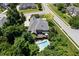 Aerial view of a property with a backyard pool, deck, mature trees, and surrounding neighborhood showcasing its setting at 14027 Waterway Blvd, Fishers, IN 46040