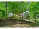 Lush backyard with mature trees, hammock, and a view of the pool area at 14027 Waterway Blvd, Fishers, IN 46040