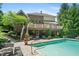 Inviting backyard oasis featuring a sparkling pool and spacious deck with comfortable seating and manicured landscaping at 14027 Waterway Blvd, Fishers, IN 46040