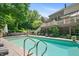 Gorgeous in-ground pool, manicured landscaping, and deck with outdoor seating, perfect for relaxing and entertaining in style at 14027 Waterway Blvd, Fishers, IN 46040