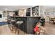 Basement bar with barstool seating and a dark granite countertop for entertaining at 14027 Waterway Blvd, Fishers, IN 46040