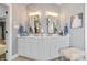 Bathroom featuring a double sink vanity with white cabinets, gold fixtures, and ample storage at 14027 Waterway Blvd, Fishers, IN 46040