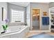 Beautiful bathroom featuring a corner soaking tub, walk-in shower, and a picture window at 14027 Waterway Blvd, Fishers, IN 46040
