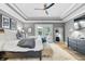 Beautiful bedroom featuring a tray ceiling, wood floors, and a stylish ceiling fan at 14027 Waterway Blvd, Fishers, IN 46040
