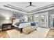 Beautiful bedroom featuring a tray ceiling, wood floors, and French doors to a balcony at 14027 Waterway Blvd, Fishers, IN 46040