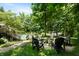 Picturesque backyard with a cozy fire pit area surrounded by mature trees, perfect for outdoor gatherings and relaxation at 14027 Waterway Blvd, Fishers, IN 46040