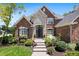 Elegant brick home with a stone archway, complemented by beautiful landscaping at 14027 Waterway Blvd, Fishers, IN 46040