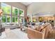 Open concept living room with a fireplace, large windows, and comfortable leather couch at 14027 Waterway Blvd, Fishers, IN 46040