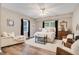 A spacious main bedroom boasts two windows, a ceiling fan, and beautiful wood floors at 14027 Waterway Blvd, Fishers, IN 46040