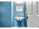 Stylish powder room with pedestal sink, decorative mirror, and painted walls at 14027 Waterway Blvd, Fishers, IN 46040