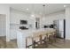 Bright eat-in kitchen boasts stainless appliances, white cabinetry, subway tile backsplash, and quartz countertops at 16485 Mount Logan Rd, Noblesville, IN 46060