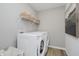 Bright laundry room featuring a washer, dryer, shelving, and luxury vinyl plank flooring at 16485 Mount Logan Rd, Noblesville, IN 46060