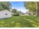 Spacious backyard with mature trees, lush green lawn and detached garage at 2020 N B St, Elwood, IN 46036