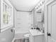 Compact full bathroom featuring a shower-tub combo, single sink vanity, and natural lighting at 2020 N B St, Elwood, IN 46036