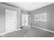 Cozy bedroom featuring neutral walls, plush carpeting, and natural light streaming through the window at 2020 N B St, Elwood, IN 46036