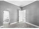 Bedroom featuring neutral walls, plush carpeting, and open doorways to the bathroom and other rooms at 2020 N B St, Elwood, IN 46036