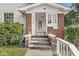 Inviting front porch with brick columns, a white railing, and space for outdoor decoration at 2020 N B St, Elwood, IN 46036