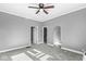 Spacious living room with neutral colors, a ceiling fan, and multiple access points to other rooms at 2020 N B St, Elwood, IN 46036