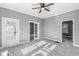 Bright living room featuring neutral tones, a ceiling fan, and multiple doorways to other rooms at 2020 N B St, Elwood, IN 46036