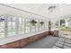 Enclosed porch featuring multi-pane windows, classic brick accents, and an indoor-outdoor feel at 2020 N B St, Elwood, IN 46036